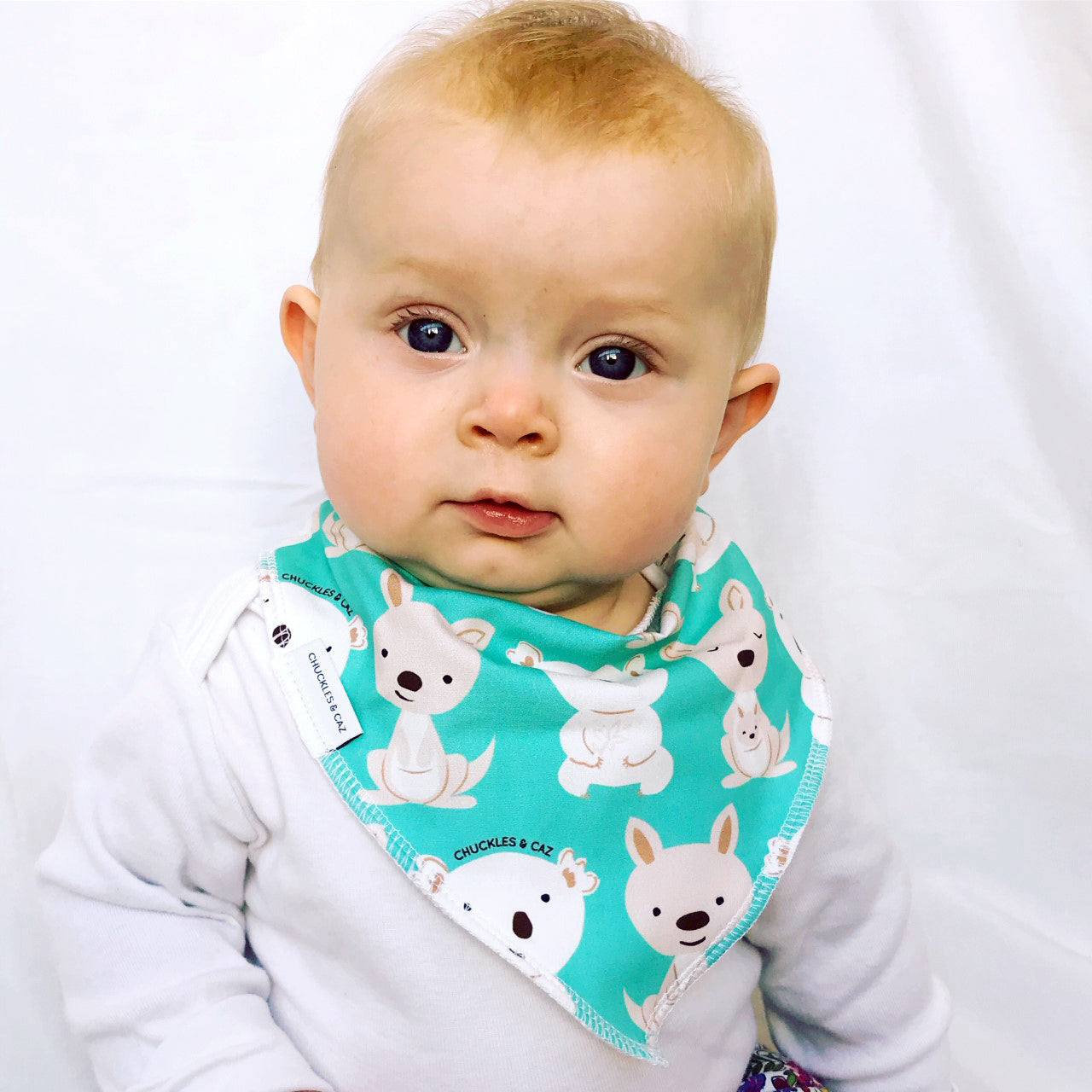 Chuckles and Caz baby bib on baby